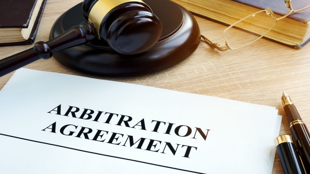 Illustration photo of an arbitration agreement and a gavel