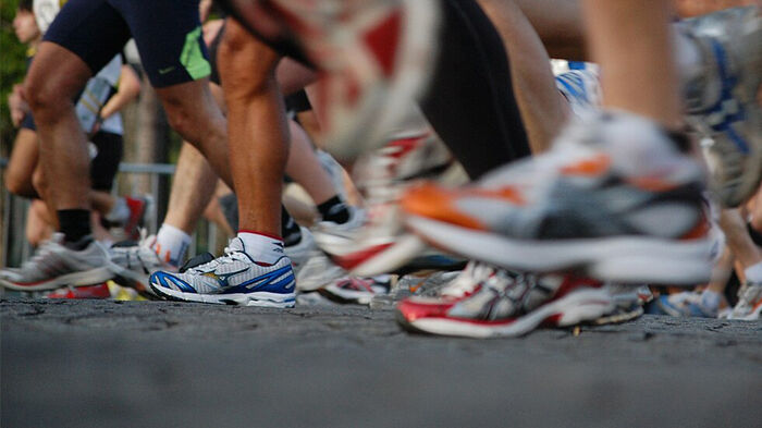 Photo of the running shoes worn by several people.