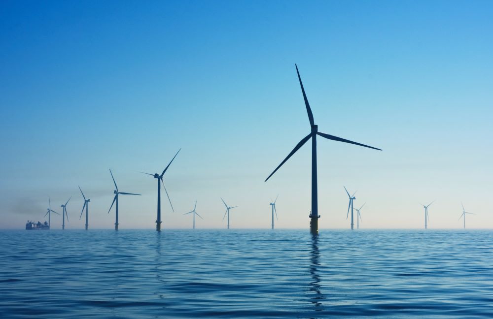 The image contains an offshore windfarm. 