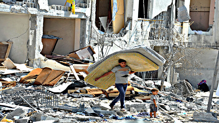 A Palestinian searches through the rubble of his destroyed home, hit by Israeli strikes in Towers Al-andaa - the northern Gaza Strip.