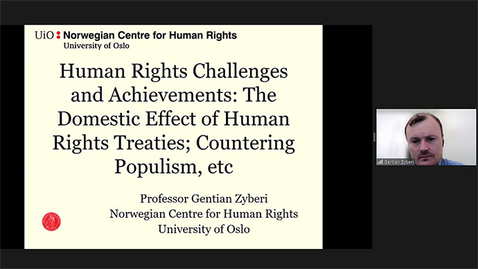 Screencapture of Zoom lecture. Powerpoint presentation titled "human rights challenges and Achievements" is in the main frame, Gentian Zyberi in a smaller frame to the right.