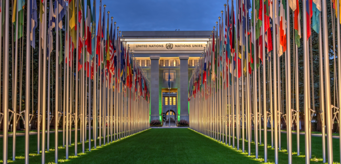 Image contains the UN building and flags 
