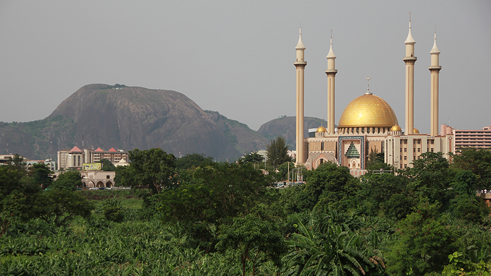 Mosque in Abuja, Nigeria. A mountain in the background, forests surrounding. 
