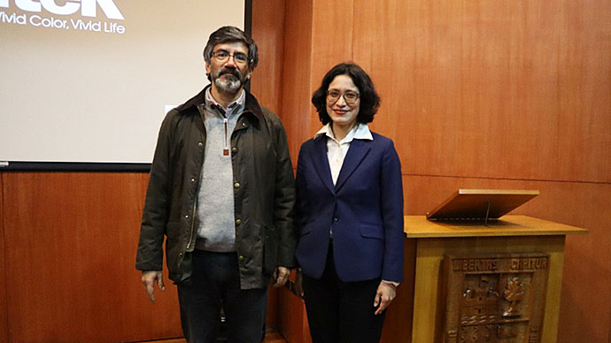 Dr. Fabian Almonacid and Dr. Natalia Torres in a lecture room, dressed formally