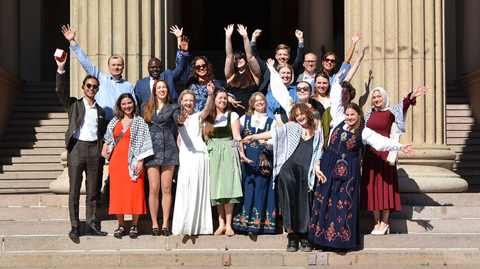 Group photo of the graduating class and Gentian Zyberi, in front of Domus Media