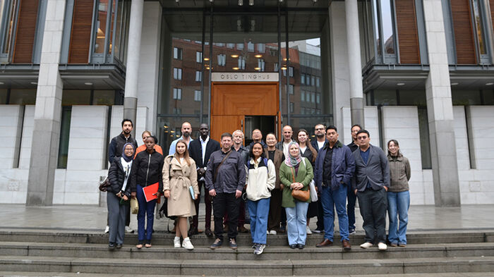 Group photo of participants in front of Oslo District Court