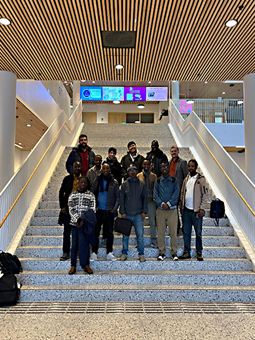 Group photo participants standing in the stairs in Domus Juridica